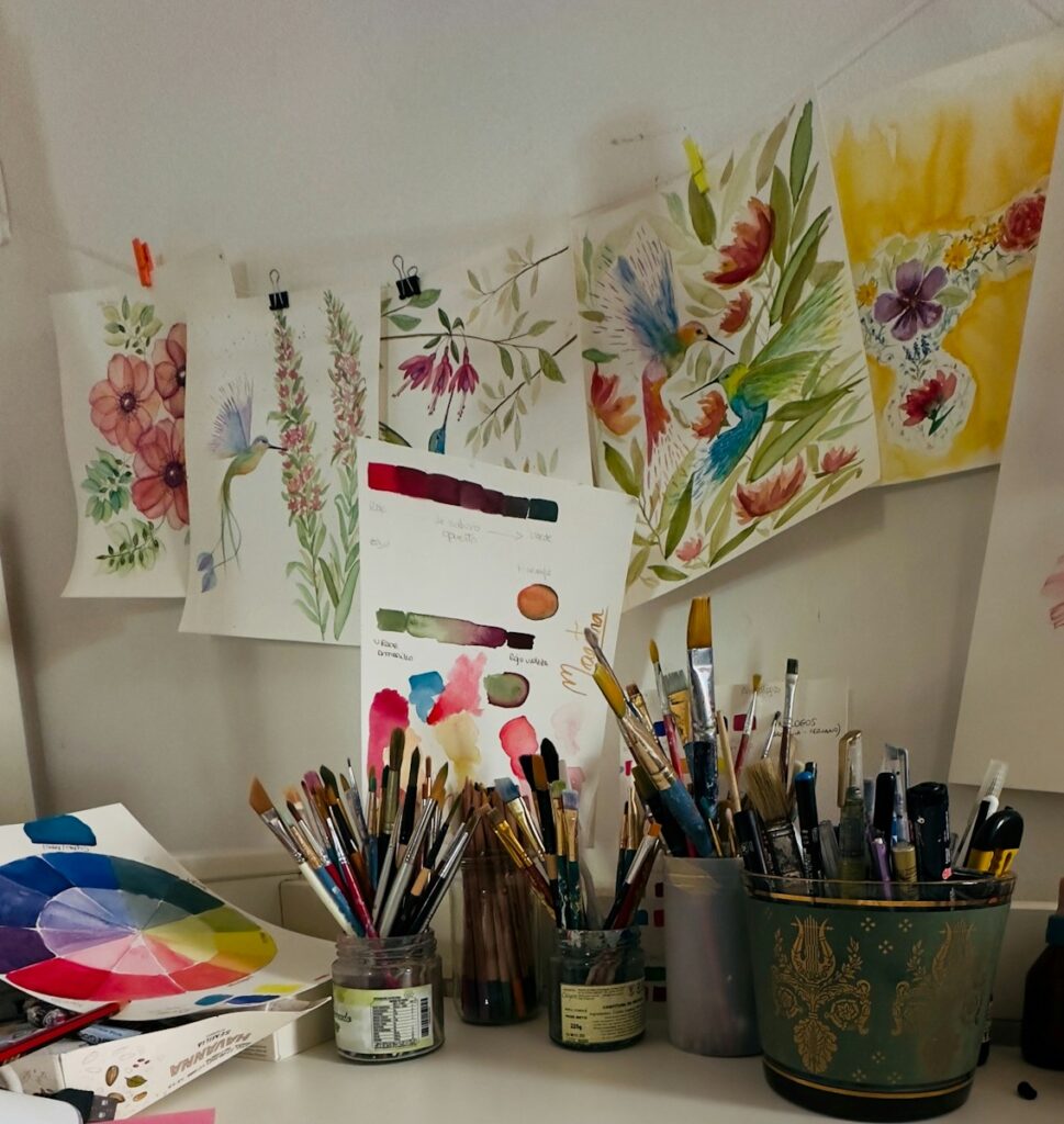 A white desk topped with lots of art supplies